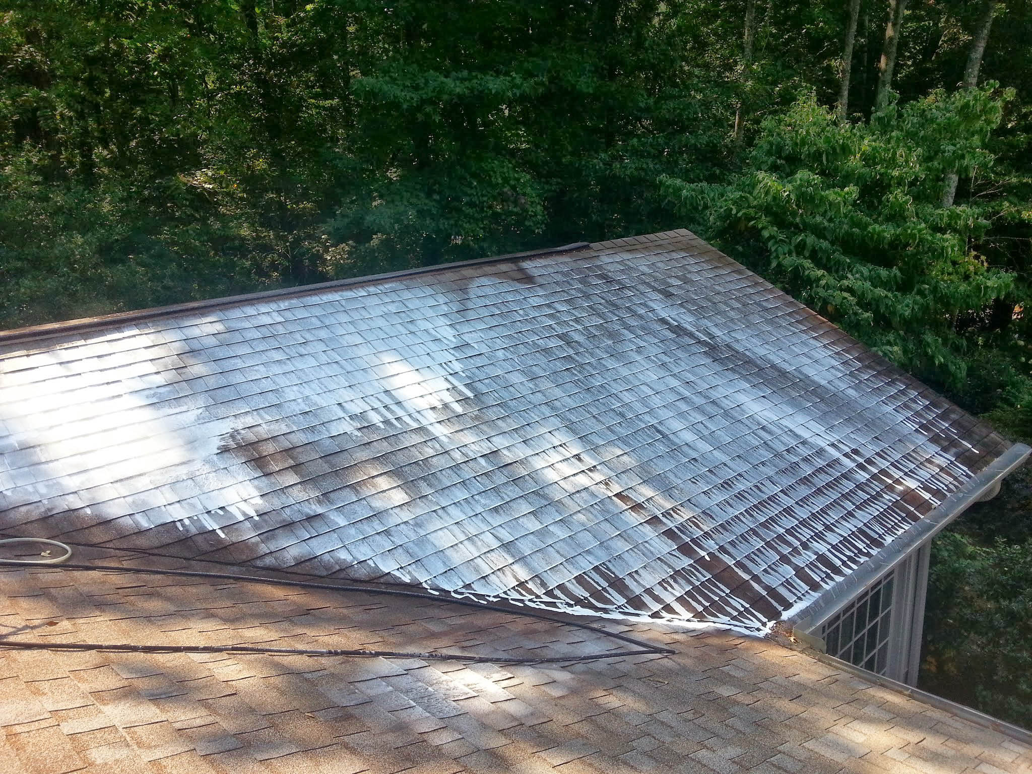 Suds on roof as Penson Pressure Washing performs Soft Wash service, before rinsing.