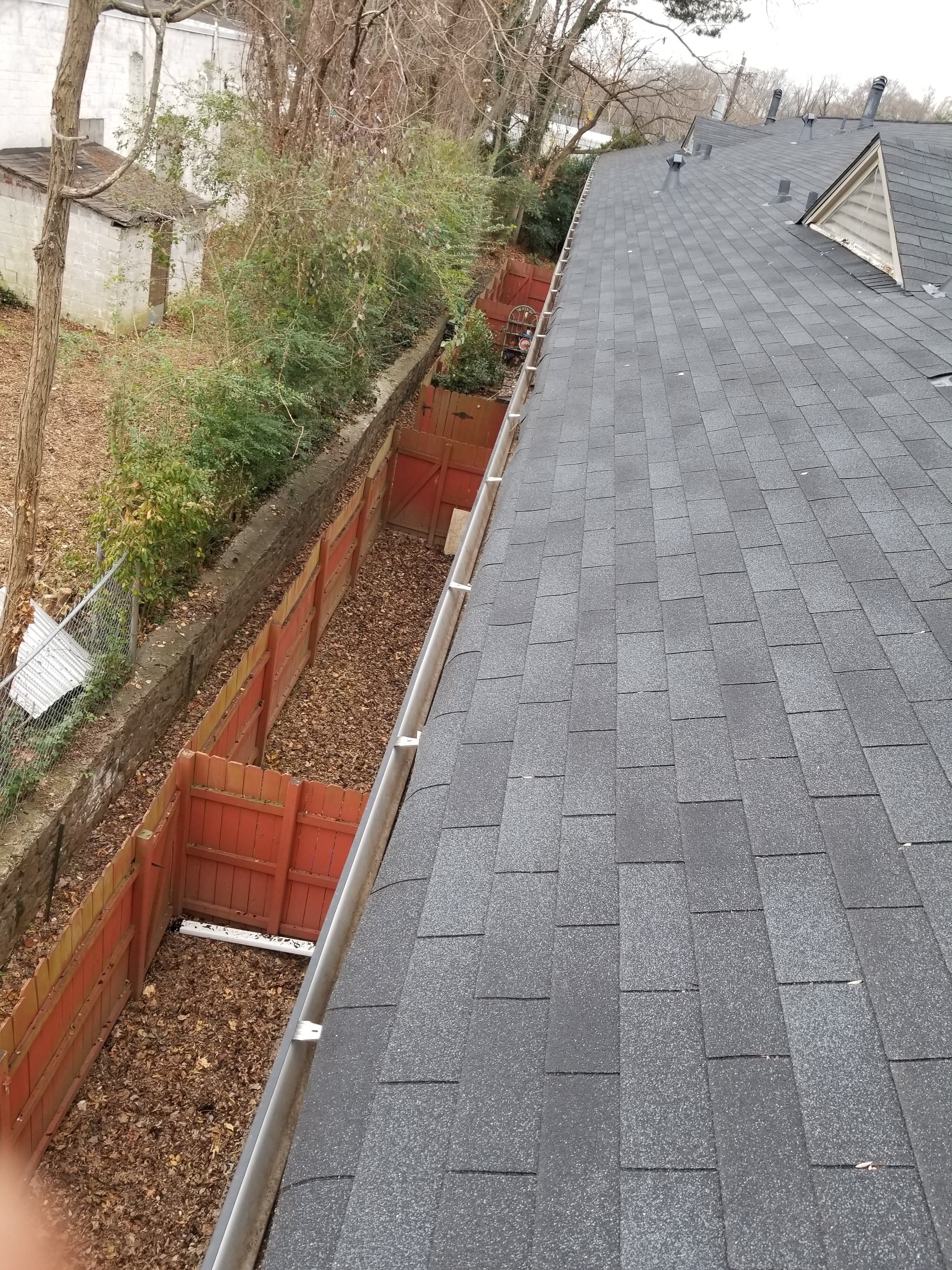 Photo of a Penson Pressure Washing client rooftop after fall gutter cleaning, free of all leaves, dirt and debris.